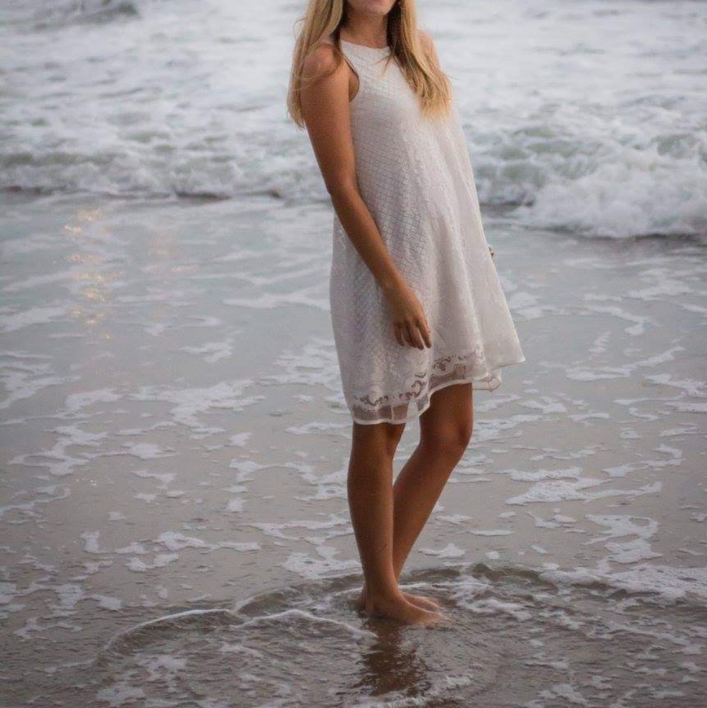 Off white sleeveless lace dress.